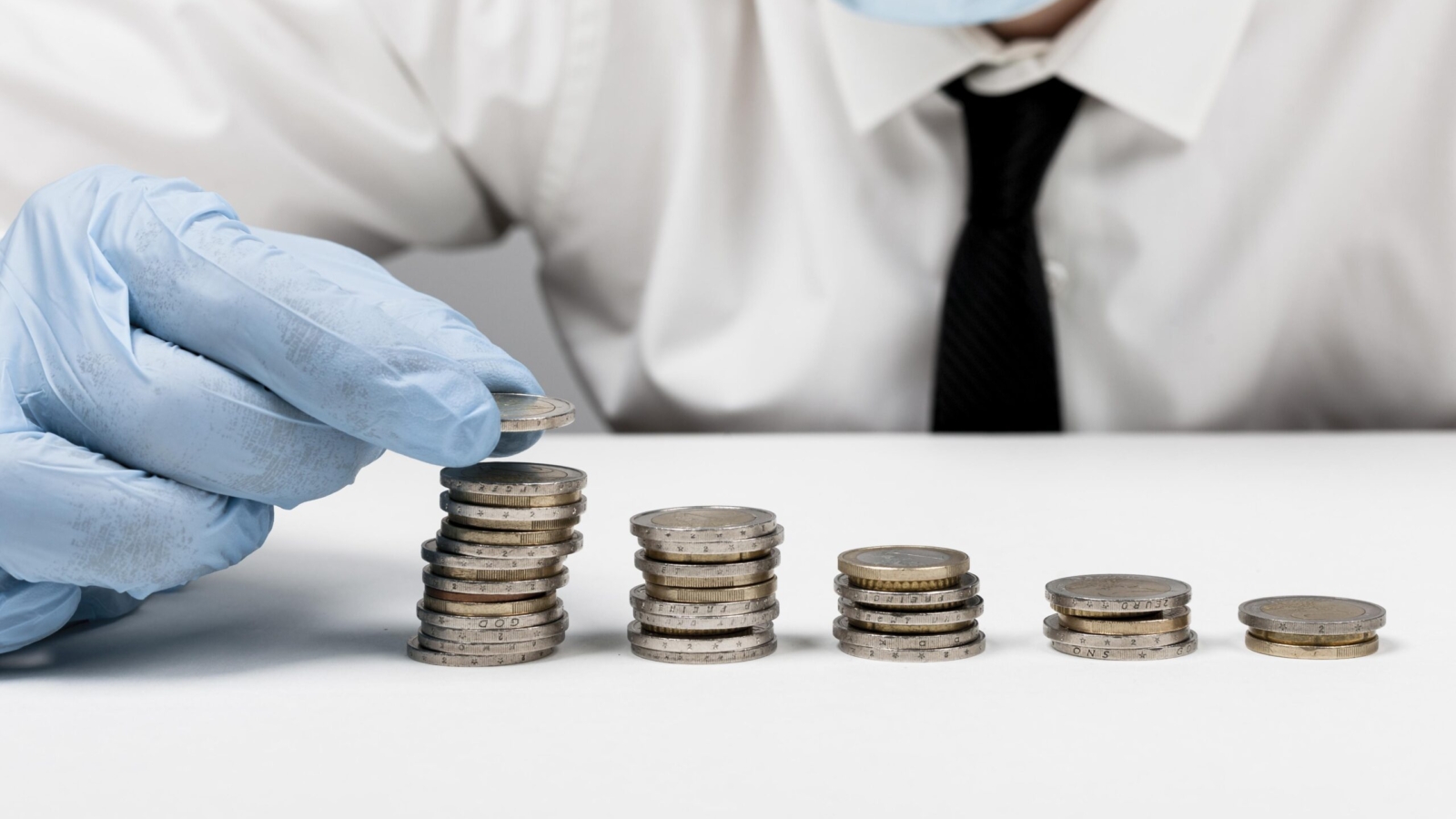 piles-coins-man-wearing-protection-gloves